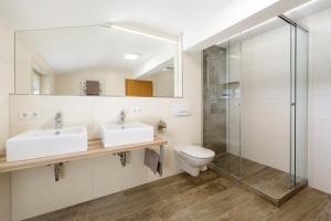 a bathroom with two sinks and a shower at Haus Ennsblick in Flachau