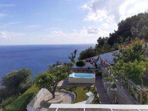 a house with a swimming pool next to the ocean at Villa Marilisa in Conca dei Marini
