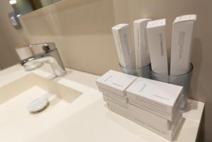 a bathroom with a sink with two boxes on it at Porta Apartament in Vlorë