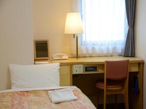 Postel nebo postele na pokoji v ubytování Nagoya Sakae Green Hotel