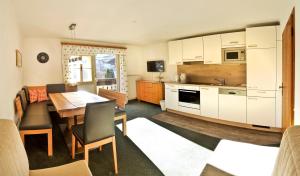 a kitchen and dining room with a table and chairs at Haus Ennsblick in Flachau
