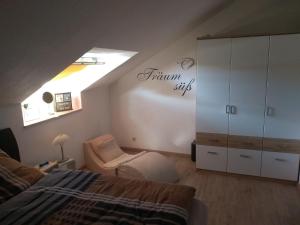 a attic bedroom with a bed and a skylight at Schanzenblick in Winterberg