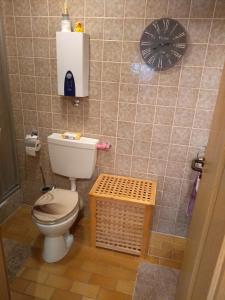 a bathroom with a toilet and a scale on the wall at Schanzenblick in Winterberg