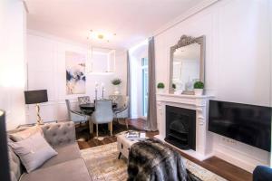 a living room with a couch and a fireplace at LA PLAZA Luxury Apartment (City Center) in San Sebastián