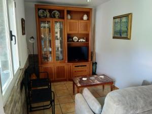 a living room with a couch and a entertainment center at Les Viesques in Colunga