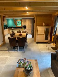a dining room and kitchen with a table and chairs at Chalet luxe L'HIBISCUS in Samoëns