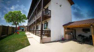 a courtyard of a building with a child playing at Vila Natalia in Vama Veche
