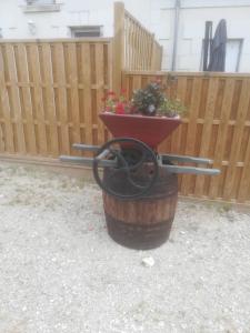 a flower pot sitting on top of a wooden barrel at Les Gites de la Musardière in Meusnes
