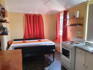 a kitchen with a piano in the middle of a room at Golden Mt Rest on James in Mount Morgan