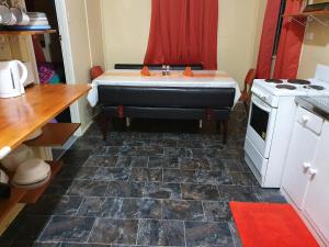 a kitchen with a bath tub and a stove at Golden Mt Rest on James in Mount Morgan