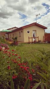 a house with a field of flowers in front of it at La Tour aux Tilleuls in Lorlanges