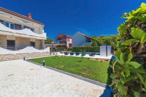 a large house with a lawn in front of it at Villa Marivel in Privlaka