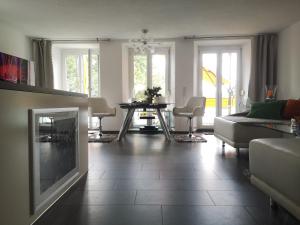 a living room with a couch and a table at Ambiente in Radolfzell am Bodensee