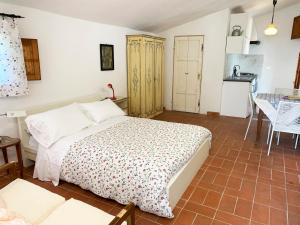 a bedroom with a bed and a table and a kitchen at S.M. IL CASTRO in Monteriggioni
