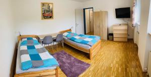 a small room with two beds and a tv at sleep24 - Monteur Zimmer In Eschelberg in Eschelberg