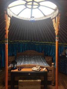 a bedroom with a bed in a blue tent at Iloons yurt in Hollandscheveld