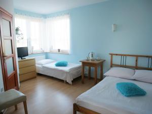 Łóżko lub łóżka w pokoju w obiekcie Słoneczny Dom pokoje i apartament na wynajem