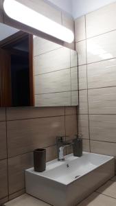 a bathroom with a sink and a mirror at Kerkini Houses in Kerkíni