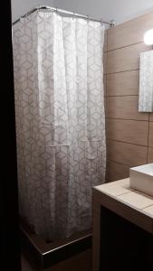 a shower curtain in a bathroom with a sink at Kerkini Houses in Kerkíni