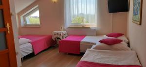 Łóżko lub łóżka w pokoju w obiekcie Słoneczny Dom pokoje i apartament na wynajem