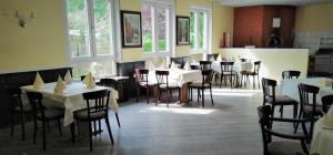 a restaurant with white tables and chairs and windows at Landhotel Schuff in Kindsbach