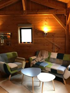 a living room with a couch and a table at Gîte Le Mazot de Vouan in Saint-André-de-Boëge