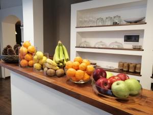 a counter with bowls of fruit on it at Mavà in Catania