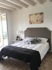 a bedroom with a bed with a black blanket on it at BellaVista Relax - Adults Only in Costermano