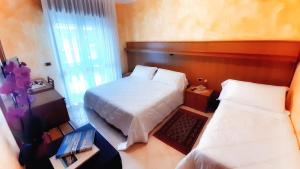 Posteľ alebo postele v izbe v ubytovaní Hotel & Wellness Fra I Pini