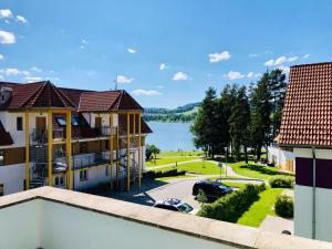 a view of the lake from the balcony of a building at Apartmán Adam in Lipno nad Vltavou