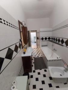 a bathroom with a sink and a toilet and a tub at WHOLE HOLIDAY HOME APARTMENT SPLENDID CIVITAVECCHIA da Pamino & Priscilla in Civitavecchia