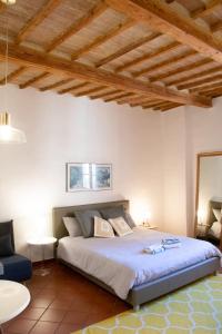 a bedroom with a bed in a room with wooden ceilings at Silviù in Perugia
