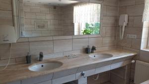 a bathroom with two sinks and a mirror at Villa Maniszewo in Serbów +16 photos