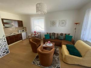 a living room with a couch and a table at Apartments Monty Podhájska in Podhájska