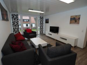 a living room with two couches and a tv at Ferienwohnung Sanwald in Schwäbisch Hall