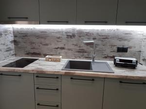 A kitchen or kitchenette at Adell Deluxe Apartments
