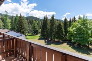 a view from the balcony of a house with a yard at Casa Santa Maria in Folgaria