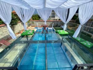 a swimming pool with green pillows on top of it at Grand Alaçatı Butik Hotel in Alaçatı