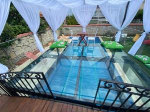 a plunge pool in a house with green pillows at Grand Alaçatı Butik Hotel in Alaçatı