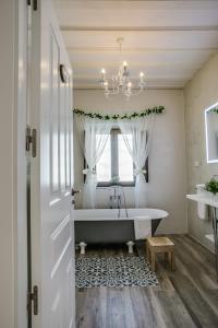 a bathroom with a bath tub and a window at Casa La Cuadra in Brunete