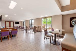 a waiting room with tables and chairs and windows at Comfort Suites of Las Cruces I-25 North in Las Cruces