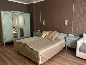 a bedroom with a bed with a dresser and a mirror at Boutique House Belevi in Nesebar