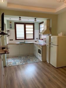 a kitchen with a white refrigerator and a sink at Boutique House Belevi in Nesebar +40 photos