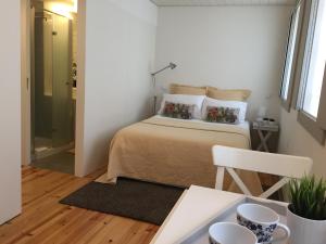 um quarto com uma cama com duas almofadas em Vila Baixa - alojamento local em Guimarães