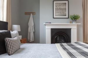 A bed or beds in a room at The Caledon Guest House 