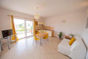 a living room with a bed and a table and a kitchen at Apartments Leonarda in Murter