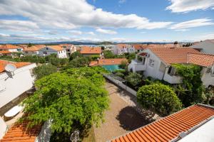 an aerial view of a city with houses and trees at Apartments Leonarda in Murter