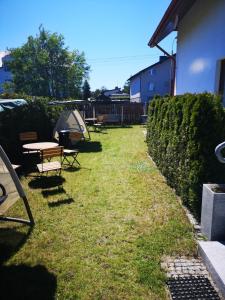 a yard with a table and chairs and a tent at Rivabell in Ostrowo