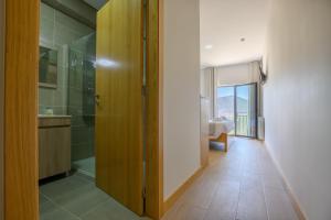 a bathroom with a walk in shower and a sink at Casa Albelo do Gerês in Montalegre