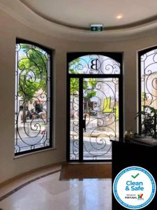 a room with three stained glass windows in a house at Bowen, Luxury Suites in Lagos